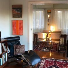 a living room filled with furniture and a flat screen tv sitting on top of a hard wood floor