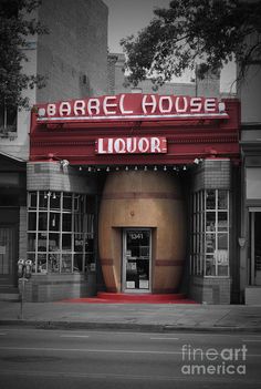 the entrance to barrel house liquor in black and white with red lettering on it's front door