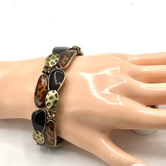 Brass tone with brown enamel stretch bracelet by Lia Sophia. Trendy Brown Metal Bracelets, Brown Metal Bangle Bracelet, Vintage Brown Metal Bracelets, Lia Sophia, Rhinestone Ring, Silver Spring, Rhinestone Earrings, Green Crystals, White Enamel