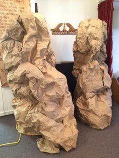 two large rock sculptures sitting on top of a carpeted floor