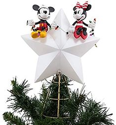 two mickey and minnie mouse figurines sitting on top of a star ornament