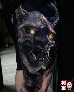 a man's leg with an evil demon tattoo on it