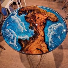 a table that has been made to look like a tree trunk with blue water on it