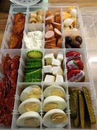 an open plastic container filled with different types of food