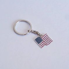 an american flag keychain on a white surface