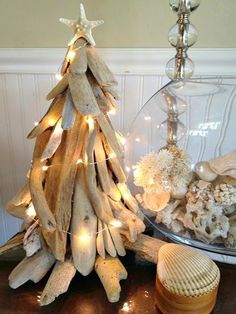 a christmas tree made out of driftwood and seashells