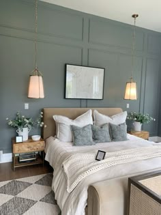 a bedroom with gray walls and white bedding