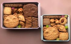 two tins filled with different types of cookies and treats on top of each other