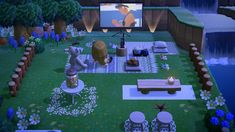 a large screen tv sitting on top of a lush green field