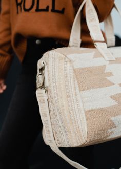 Tan and cream Aztec inspired duffel Zipper closure with interior zipper pocket and 2 small open pockets Removable strap Measures 20" x 8" x 11" 100% Cotton Lining: 100% Polyester White Duffle Bag With Zipper For Everyday Use, White Duffle Bag With Zipper Closure For Everyday Use, White Weekender Bag With Zipper For Daily Use, Beige Rectangular Weekender Bag With Zipper, Rectangular Beige Weekender Bag With Zipper Closure, Beige Duffle Bag For Weekend Trips, White Rectangular Weekender Bag With Zipper, White Rectangular Weekender Bag With Zipper Closure, White Travel Bag With Zipper Closure For On-the-go