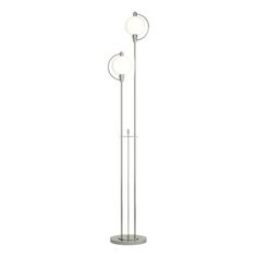 a metal floor lamp with two lights on each side and one light on the other