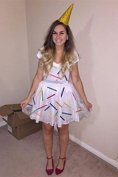 a woman wearing a birthday hat and dress with sprinkles on the skirt