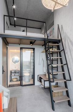 a loft with stairs leading up to the bedroom