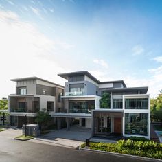 a large modern house with lots of windows and balconies