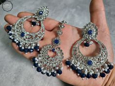 We are thrilled to introduce our exquisite collection of Indian earrings in Silver and Navy Blue. These stunning earrings are crafted to enhance your style, whether you're attending a party or a wedding ceremony. They are guaranteed to make you stand out in the crowd.Elevate your style with these stunning Earrings. Make a bold fashion statement and turn heads wherever you go. Shop our stunning collection today!We have a wide range of colors available, so be sure to check our other listings to find the perfect match for your style. In addition to this earring, we have a wide variety of Indian Pakistani jewelry. Explore our shop to discover the perfect piece for your collection. If you're having trouble viewing our photos, try increasing your screen brightness for a clearer image.We aim to d Navy Blue Earrings Wedding, Navy Blue Lehenga, Blue Earrings Wedding, Navy Blue Earrings, Heavy Earrings, Blue Lehenga, Jewel Wedding, Pakistani Jewelry, Indian Earrings