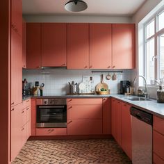 a kitchen with red cabinets and white counter tops