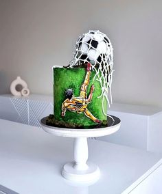 a cake with a soccer goalie on it and a ball coming out of the net