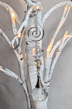 a white tree with some lights in it