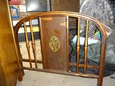 an old wooden bed frame in a room