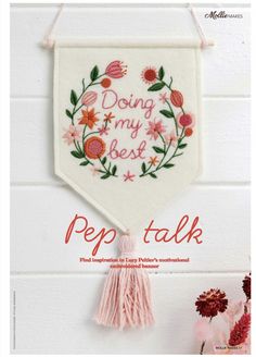 a cross stitch banner hanging on the wall