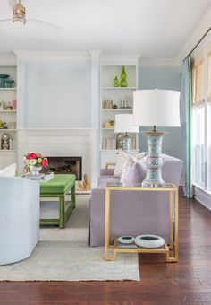 a living room filled with furniture and a fire place in the middle of a room