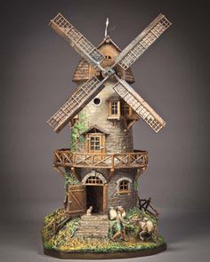 a figurine of a house with windmills on it