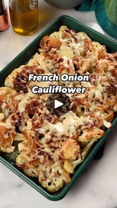 french onion cauliflower casserole in a green dish on a marble counter