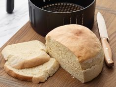 a loaf of bread sitting on top of a cutting board next to a knife