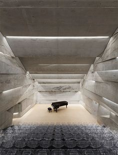 a black piano sitting in the middle of a room