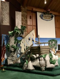 a model of a pirate ship on display in a room with green carpet and wooden paneled walls