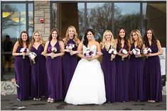 a bride and her bridal party in front of a building