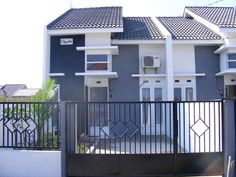 an apartment building with black iron fence and gate