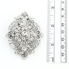 "Stunning rhinestone brooch jewelry embellishment, which can be used for your DIY project - Glam, Vintage inspired wedding, ring pillow, invitations, cake decorations, event decor, crafts, scrap booking, jewelry gift and much more! Size: 2 1/2\"H x 2\"W Stone color: Austrian, clear Metal: Silver plated This rhinestone silver brooch can be ordered with pin in the back to add to wedding gown or dress sash, to wire into brooch bouquet, or any number of other craft projects; or without the pin as a Silver Embellished Wedding Brooches, Wedding Silver Brooches With Sparkling Stones, Wedding Crystal Brooches With Sparkling Stones, Silver Rhinestone Brooch For Vintage Events, Silver Crystal Brooches With Sparkling Stones, Brooch Wedding, Bouquet Brooch, Dress Sash, Dress Pin