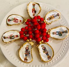 a white plate topped with oysters covered in red berries and nutcrackers