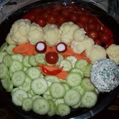 a platter filled with cauliflower, carrots and other vegetables