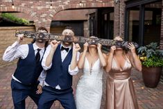 the bride and grooms are holding up their skateboards in front of their faces