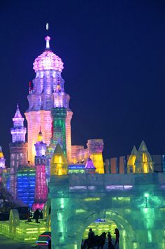 an ice castle is lit up at night