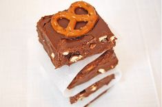 two pieces of chocolate with pretzels on top