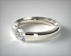 a white gold wedding ring with a single diamond