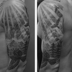 the back of a man's arm with an eagle and trees on it