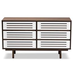 a white and brown dresser sitting on top of a wooden table