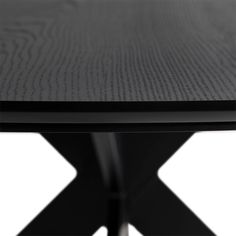 a close up view of a black table with an x design on the top and bottom