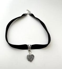 * This handmade boho choker is simple, elegant and so boho.  * Black Velvet ribbon with antique silver heart pendant Love this. * Choker is 13 inches with 2 inches of adjustable extender chain. * Velvet lace is so delicate Please Avoid perfumes and lotions and remove before swimming and bathing etc.    Avoid leaving your jewelry in damp environments. * Gently clean with dry cloth and store in the plastic zip bag and box supplied. * Each piece is packaged with love and ready for gift-giving or just for your own beautiful self! Adjustable Choker For Valentine's Day Festival, Adjustable Valentine's Day Festival Choker, Adjustable Valentine's Day Choker, Adjustable Black Choker With Heart Charm, Black Heart-shaped Jewelry For Festivals, Black Heart-shaped Festival Jewelry, Black Bohemian Heart-shaped Jewelry, Black Heart Shaped Bohemian Jewelry, Black Heart-shaped Bohemian Jewelry