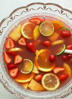 a glass bowl filled with fruit and water