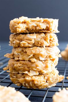 three oatmeal cookies stacked on top of each other in front of a cooling rack