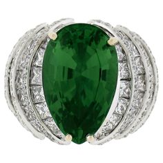 --Stones:-- 1 Natural Genuine Chrome Tourmaline - Pear Cut - Prong Set - Vivid Green Color - 8.55 exact ** See Certification Details Below for Complete Info ** 148 Natural Genuine Diamonds - 60 Princess & 88 Round Brilliant Cut - Channel & Pave Set - G-J Color - VS1-SI2 Clarity - 5.20ctw approx. Total Carat Weight: 13.75 approx. Material: Solid 18k White Gold w/ Yellow Gold Prongs Weight: 19.77 Grams Ring Size: 5.5 (Fitted on a finger. We can custom size this ring.) Ring Width: 18.6mm (0.73") (top of ring) - 8.3mm (bottom of shank) Ring Height: 10.3mm rise off the finger Condition: Few diamonds have tiny chips shown under magnification. Excellent condition. Comes with the original GIA certification for the tourmaline. Stock Number: MK-490107016-24042617 --Certification Details:-- Laborator Chrome Tourmaline, Diamond Cocktail Ring, Diamond Cocktail Rings, Gem Stone, Ring Ring, Pear Cut, Cocktail Ring, Cut And Color, Cocktail Rings