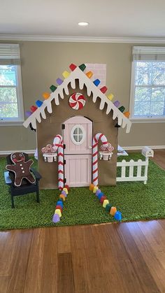 a gingerbread house is decorated with candy canes and candies for the holiday season