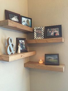 three wooden shelves with pictures and candles on them