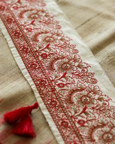 Here's a delicate floral embroidered trim created with Madhubani style embroidery. The base fabric is an rich off-white/ cream colour cotton, with fine embroidery in red. Madhubani is a very distinct style of painting from the Mithila region of India. Traditionally created by women to decorate the mud walls of their homes, these have since graduated to adorn clothes, fabrics, tapestries and décor. And have evolved from the form of paintings to embroideries, which are so intricate they look like Madhubani Embroidery, Fine Embroidery, Floral Saree, Saree Border, Red Embroidery, Embroidered Trim, Cream Colour, Indian Fabric, Velvet Trim