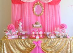 a pink and gold princess birthday party with lots of desserts on the buffet table